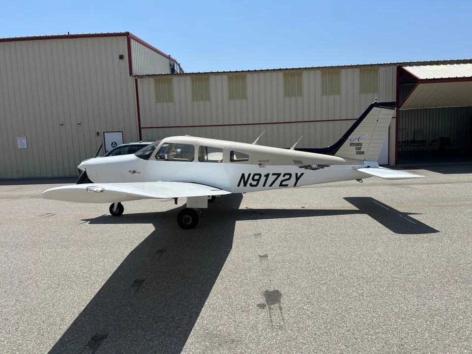 Left-side profile of Piper Warrior II N9172Y, showing the low wing and Accelerated Flight Academy tail logo