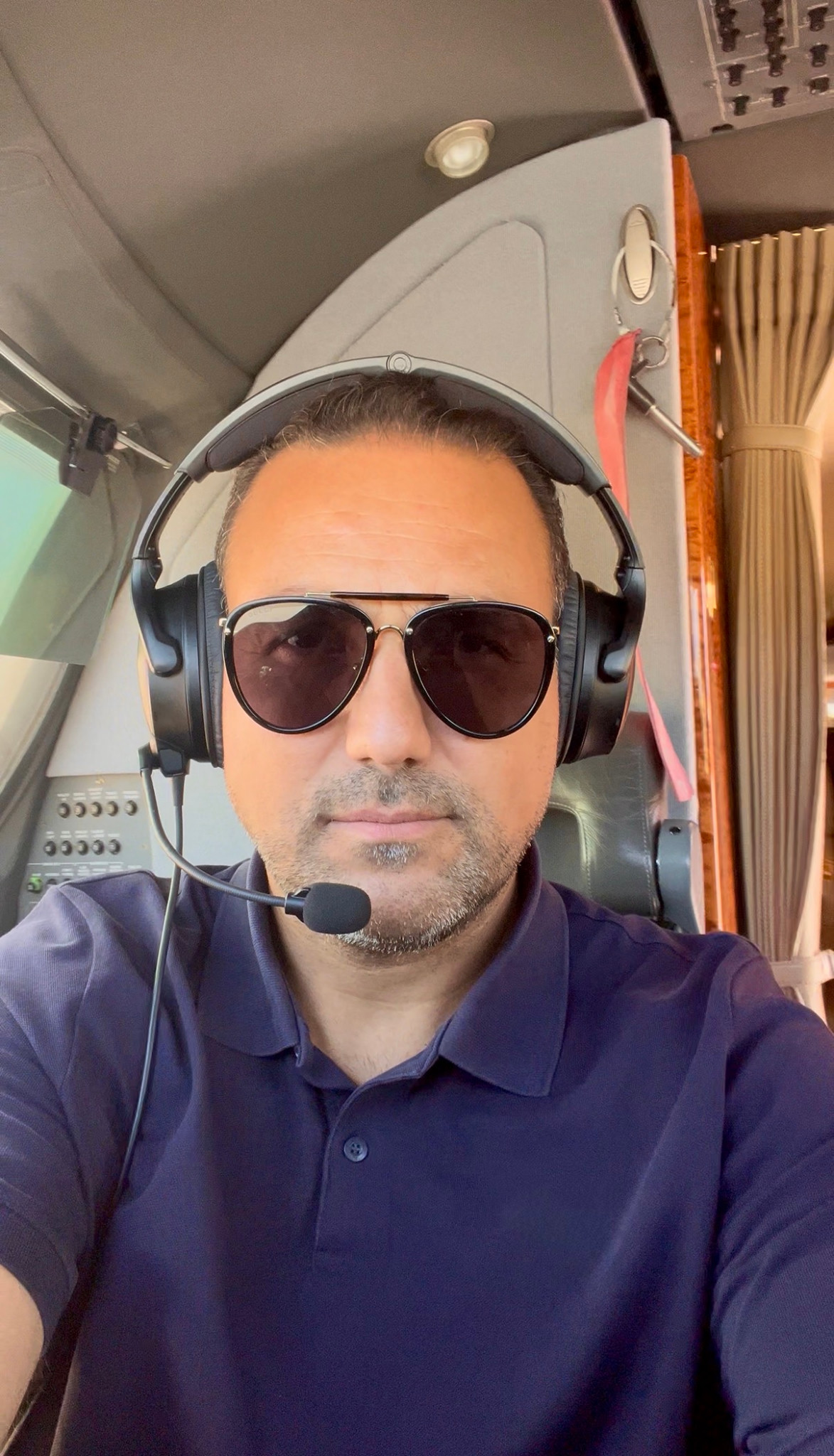 Reza Sabzi, CFI and CFII flight instructor, wearing a headset in an aircraft cockpit
